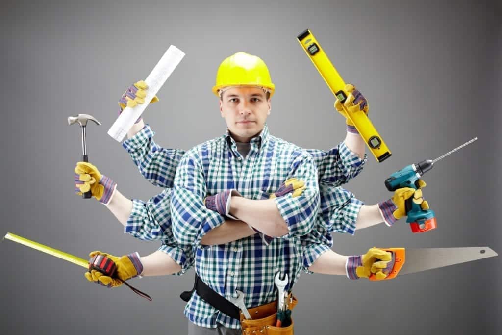 Portrait of serious craftsman with different tools in six hands